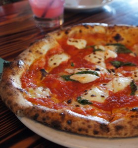 Margherita Pizza, bundles of burrata atop a perfectly seasoned tomato sauce!